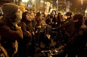 Protesters link arms as they shout at police officers during Occupy Seattle's protest against JPMorgan Chase CEO Jamie Dimon in Seattle N